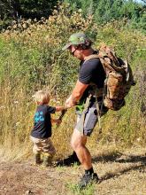 Nick and son pull broom together